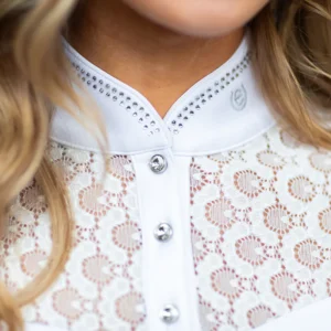 A close up of the collar on a woman wearing white